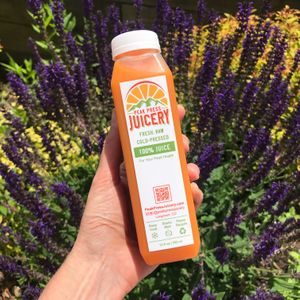 Bright juice (carrot, green apple, ginger, turmeric, lemon) at Peak Press Juicery in Longmont