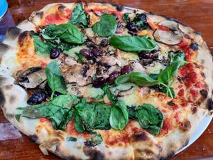 Mushroom, basil, spinach, black olives, garlic oil, and vegan cheese pizza at Just Pizza & Pasta in Douglas