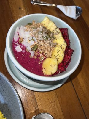 Sunset Bowl - Blended pitaya (dragon fruit), banana, plain yoghurt (we opted for coconut yoghurt). lopped with granola and 2 choices fruits.  at Coffee & Thyme in 