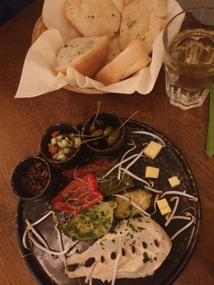 Appetizer plate with hummus, crispy bread, lentils, salad, kapern, and some antipasti at The Keep Garden Kitchen in Salzburg
