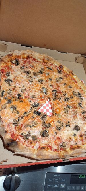 A delicious vegan void pizza with a bite taken out at Sizzle Pie - Beaverton in Beaverton