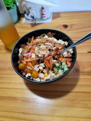A vegan bowl with tofu, edamame, shredded carrots, crispy onions, cucumber, kale and quinoa  at Luna's Bowls in Liberia