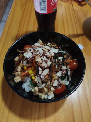 Vegan poke bowl (tofu, rice, carrots, jalapenos, corn, nori, almonds etc. with teriyaki and sriracha) at Luna's Bowls in Liberia