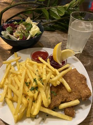 Schnitzel mit pommes & salat (€8.60) w/ sparkling lemon water 😋 at Cafe Erde in Graz