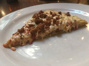 Vegan pizza with cheese and sausage at District of Pi Pizzeria in Washington
