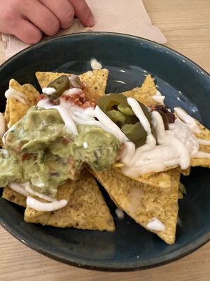 Nachos with cheese, peppers, guacamole… worth a try!   at La Oveja Negra in Madrid