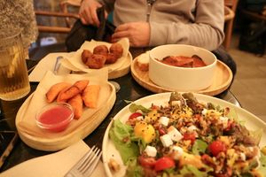 selection of tapas - mango salad, empanaditas, croquettes, chorizzo at La Oveja Negra in Madrid