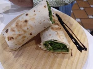 Wheat tortilla filled with hummus, fresh spinach, nuts, dry tomato and cucumber at La Oveja Negra in Madrid