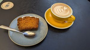 Oat milk latte and vegan carrot cake. at La Wilderie in Lille