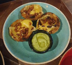 Plant-based Cheese & Bacon loaded potato skins: Meatless Farm plant-based bacon pieces, Applewood vegan cheese, avocado & lime dressing and sliced spring onions at TGI Fridays in Bolton