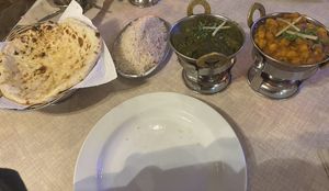 Left to right at the front of the photo - peshwari naan, coconut rice, sag aloo, Chana masala  at Sabor de la India in Tenerife