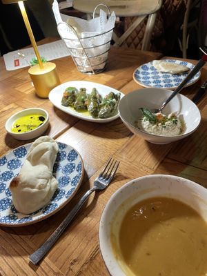 Pita with olive oil, dolmades, baba ghanouj, and lentil soup  at Agora Tysons in Mclean