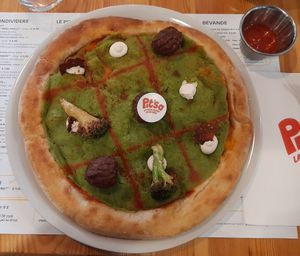 Pizza with broccoli cream, tomato sauce, plant-based meatballs, fried broccoli heads, cashew spread, dried tomatoes, lemon zest at Pit'sa in Bergamo