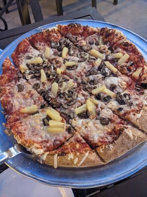 Pineapple and mushroom pizza on hand tossed thin crust at Glass Nickel Pizza Co in Appleton