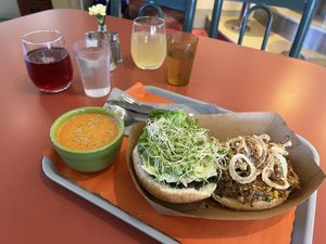 Seed & bean burger with a cup of Indian Coconut Tomato Soup. And 2 botanical tonics    at Our Food Is Art Restaurant and Bar in Crestone