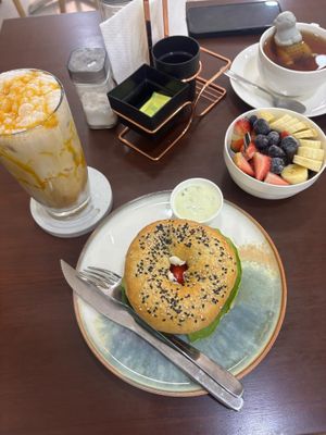 Bagel, caramel coffee and fruit bowl at Coconela in Santa Cruz