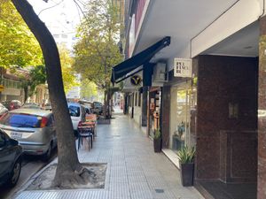Street--notice "V" sign and outdoor seating at Craft Vegan Bakery Botánico in Buenos Aires