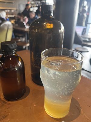 Mix yourself lemon sparkling soda- homemade lemon syrup and bottle of sparkling water  at Truth Coffee Roasting in Cape Town