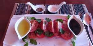 Tomato salad with olive oil and balsamic vinegar at SpringRiver Resort & Restaurant in Ban Tiou Village