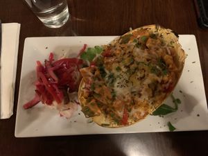 Stuffed spaghetti squash with vegan “chicken”, veggies, and vegan cheese  at The Purple Elephant in Northport