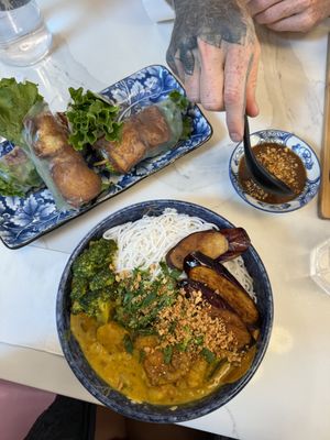 Curry vermicelli bowl with tofu salad rolls  at Ôngbà Vietnamese Eatery in Vancouver