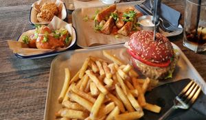 Beyond Meat burger with fries, seitan and cauliflower wings all vegan. Top left are mac and cheese balls which are vegetarian (not mine) at BrewDog in Hull