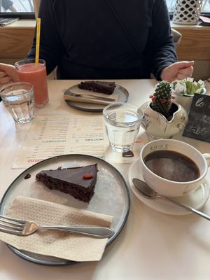 Large Americano and Raspberry cake. Complementary water   at Coffee Room in Amsterdam