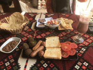 Vegan breakfast (vegan sausages and balls, falafel, toast and tomatoes, foul) and American breakfast (waffles and pancakes, probably not vegan)    at Thebes Bar And Grill in Luxor