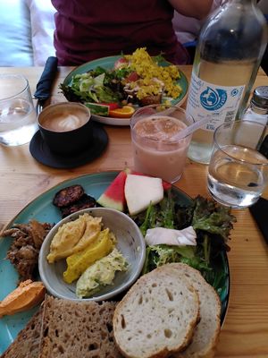 Breakfast with different home-made spreads, grilled tempeh, pulled jackfruit, salad and melon slices at schnack in Mainz