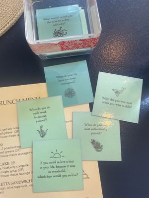 Thought provoking cards at the table  at Nourish Kitchen & Cafe in Victoria