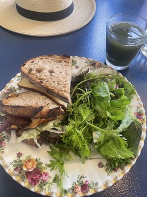 Smoked Tofu Muffuletta Sandwich - vegan (bacon added-not vegan) and one of their fresh juices  at Nourish Kitchen & Cafe in Victoria