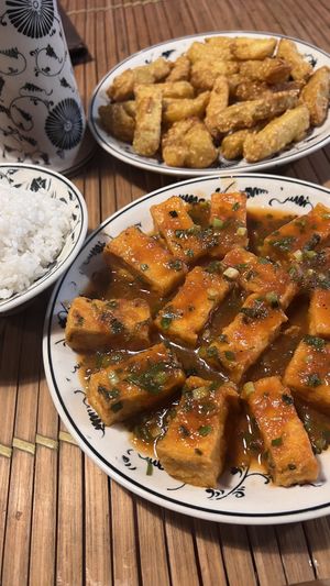 Tofu in tomato sauce and sweet potatoes fried with sesame.  at Tam Coc Ngo Dong Homestay and Vegan Restaurant in Ninh Binh