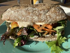 Sandwich with grilled eggplant, mustard dressing and greens  at The Break Cafe in Thisted