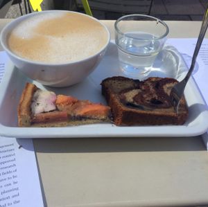 coffee with oat milk and 2 little slices to try. delicious! at Deli Kitchen in Munich