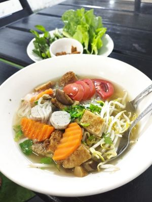 tasty food with larp, noodles and vegetables at Kaun Im Yok Vegan Restaurant - H&H in Vang Vieng