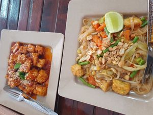 Left: fried tofu with souce on top, right: pad thai at Kaun Im Yok Vegan Restaurant - H&H in Vang Vieng