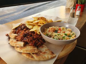 Platter with Beyond Burger, Chips, mushroom Gyros and salad at Veganato in Crete