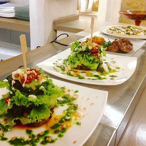 Life Bistrot recipe: our aubergine parmigiana, with fresh lettuce and tomato, cashew nut cream, toasted almonds on top and pesto at Albergo Diffuso Volterra in Volterra