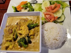 Veggie coconut curry with steamed vegetables and a garden salad at Swings Restaurant & Bar in San Pedro