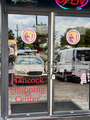 Kismet Cafe door with hours as of June 2023 at Kismet Cafe in Austin