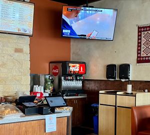 Supplies area & TV in every corner at Kismet Cafe in Austin