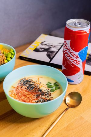 Ginger-pumpkin soup and 100% coconut water at Acai Poke in Prague