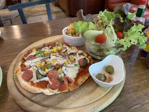 Vegan pizza with mock sausage and yummy side salad at Bonita Cafe and Social Club in Bangkok