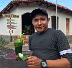 Barista Jose del Carmen serving a chaya smoothie at Centro PUMA in Altagracia