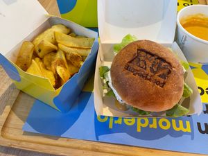Cheesy Cheddar Explosion Burger with fries at Impact Food in Rome