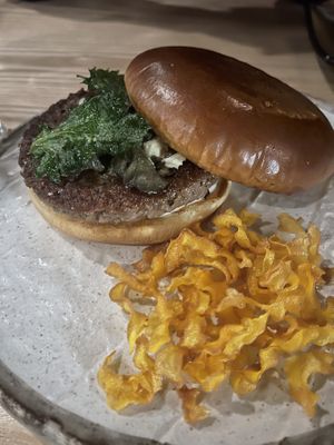 Burger with shishito peppers, mushrooms, and shiso on a brioche bun  at Kusaki - Pop-up in Los Angeles