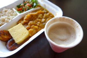 Cucumber stoba, brown rice, house salad and fried plantain with maca banana shake. at The Magic Mushroom Kitchen in Oranjestad