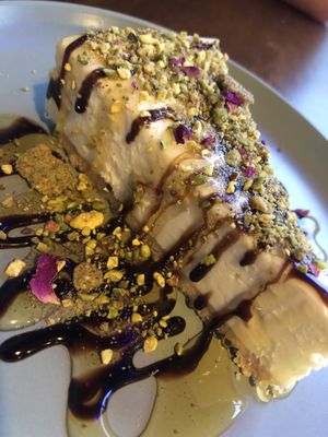 Pistachio cheesecake with rose, syrup and chocolate sauce  at Pistachio Bar & Kitchen in Nottingham