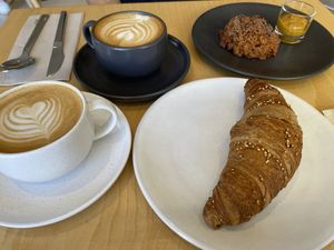 Capuccino, flat white, vegan croissant  at Numa Café - AMUN Cafe in Lisbon
