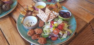 Falafels, hummus, cous cous, potatoes, salad and dips at Alubia plant power in Mallorca